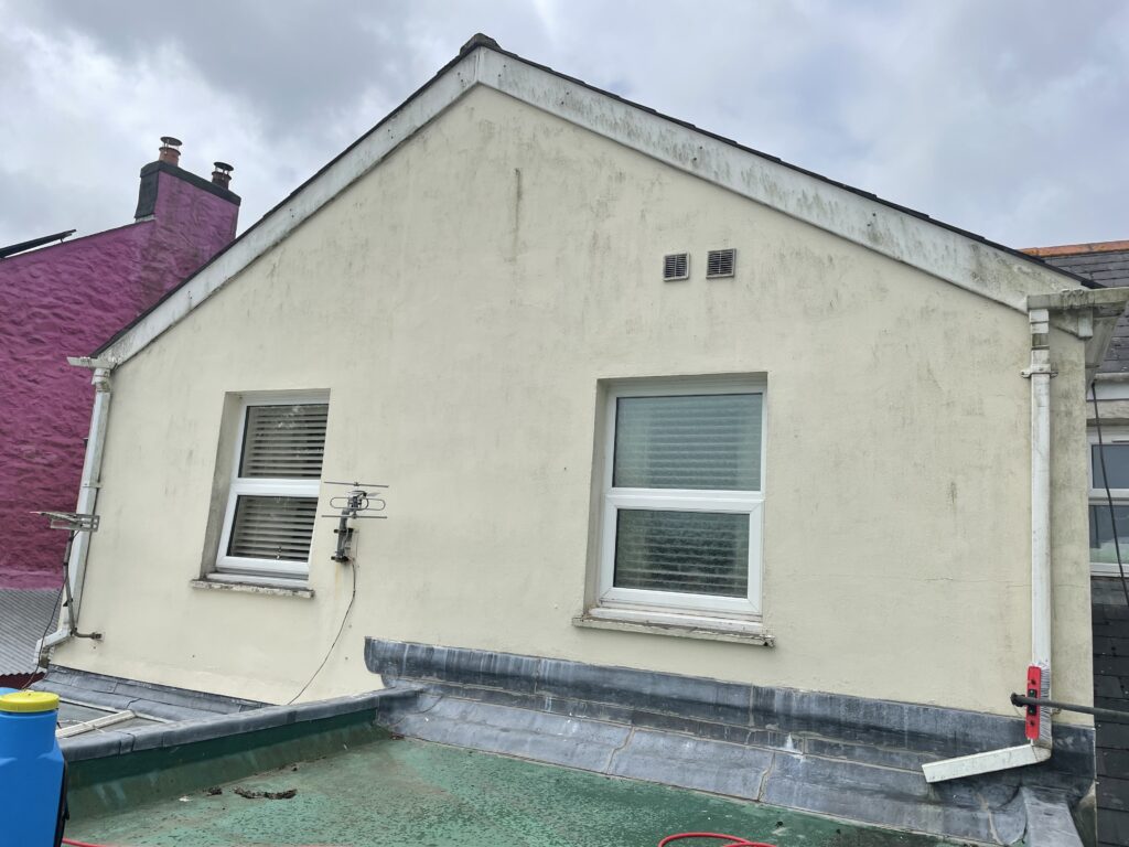 Gable end of a property clean before softwash treatment.