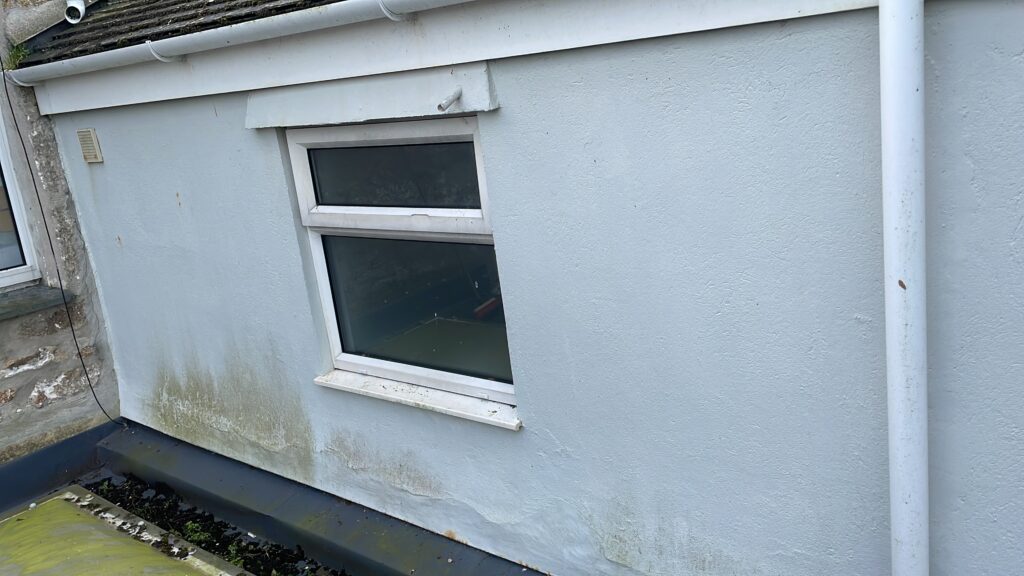 Soft washing around the back of of a property (before)